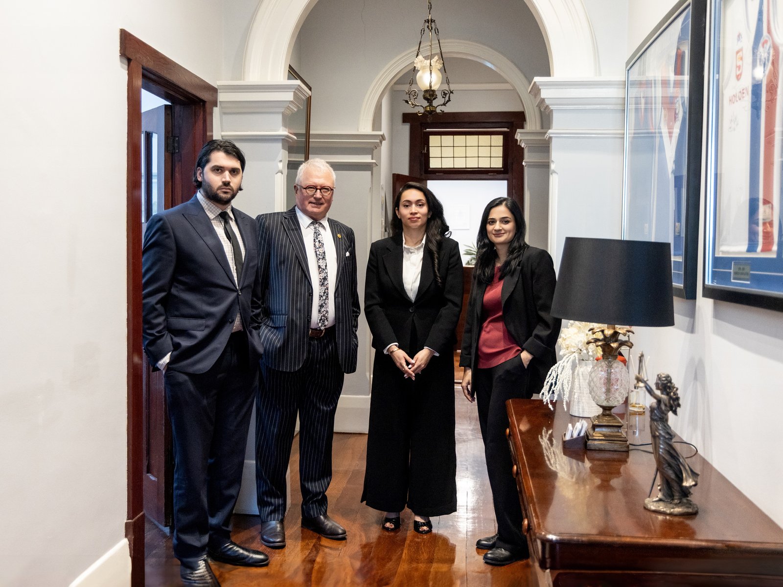 Jack Clark, Steven M Clark, Zahra Amin and Mahima Sobti in the heritage hallway of the Gawler office