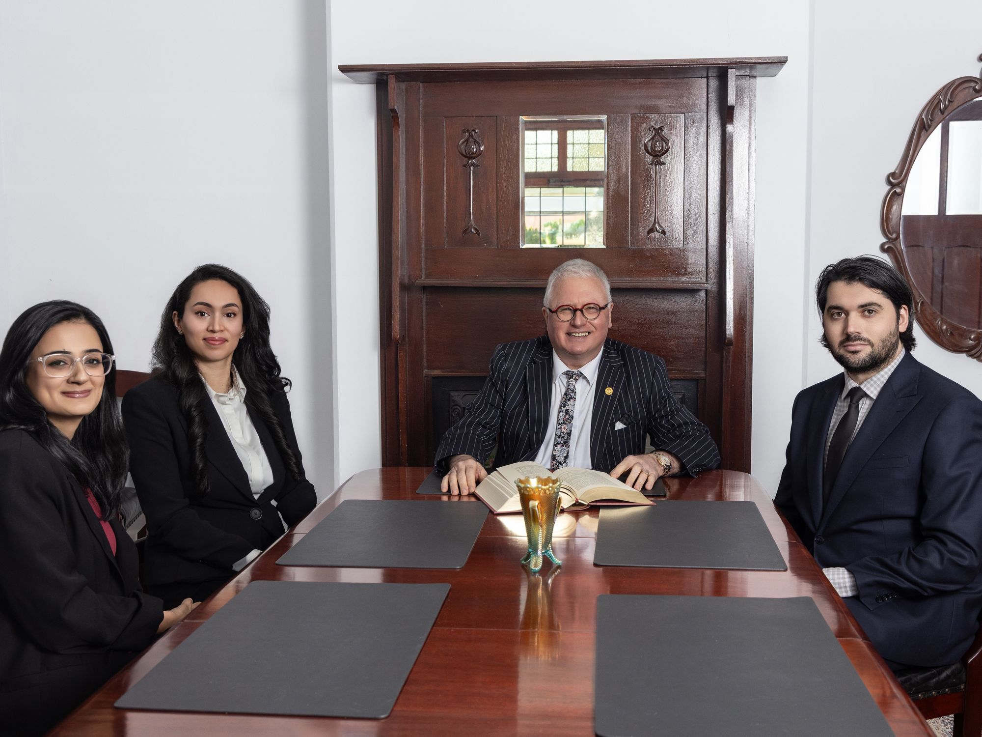 The Steven M Clark Lawyers team at the boardroom table